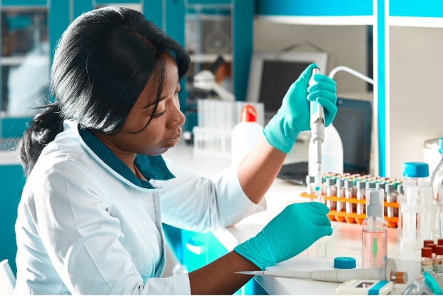 Black female scientist doing research with pipette